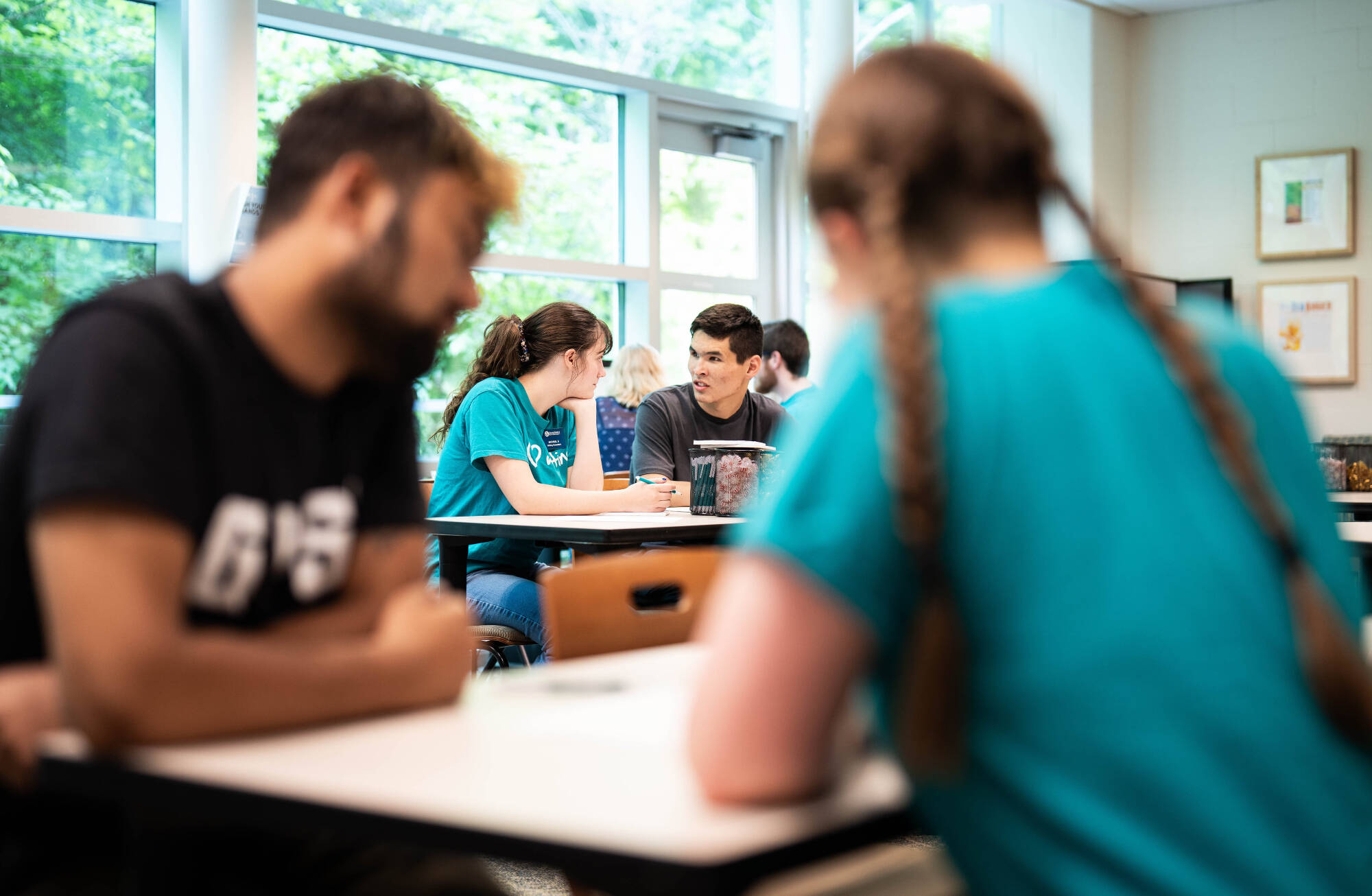 View of consultants and students working in the writing center